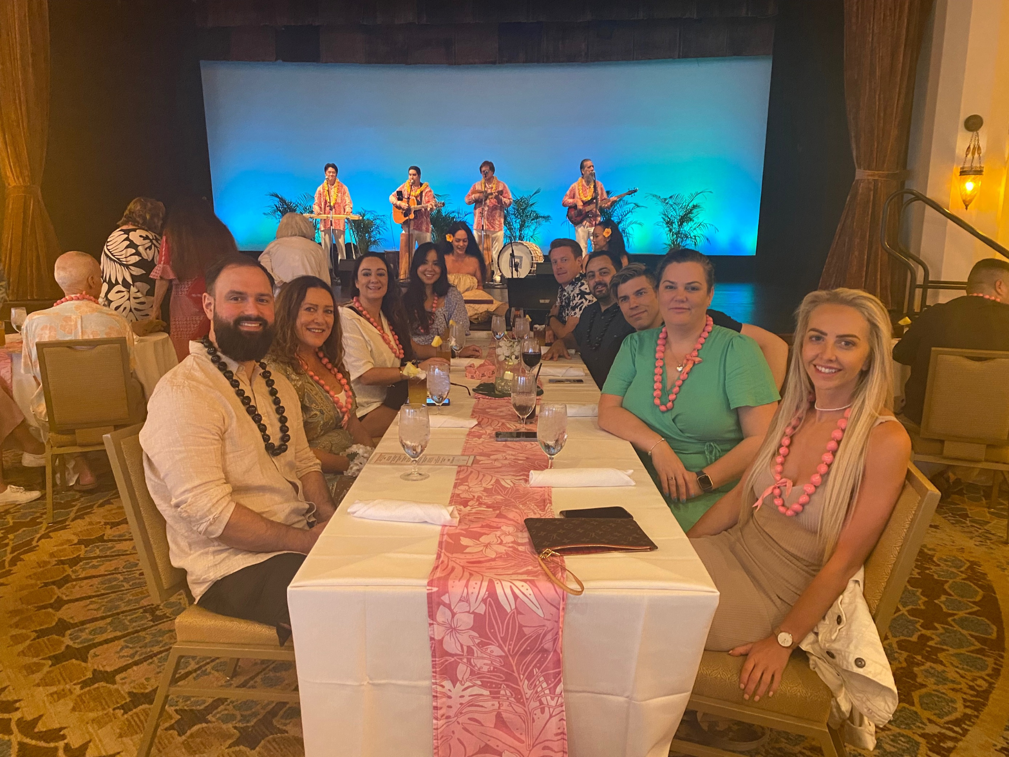 The team sharing a meal at a luau