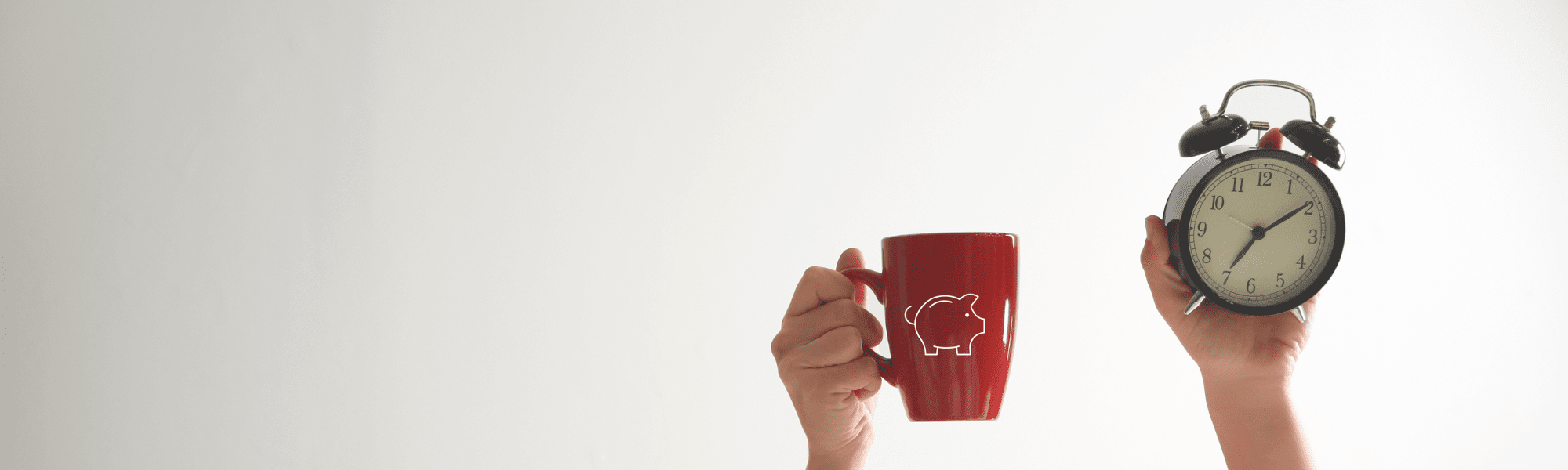 Person holding a red cup with a white pig icon outline on it in one hand and a black alarm clock in the other